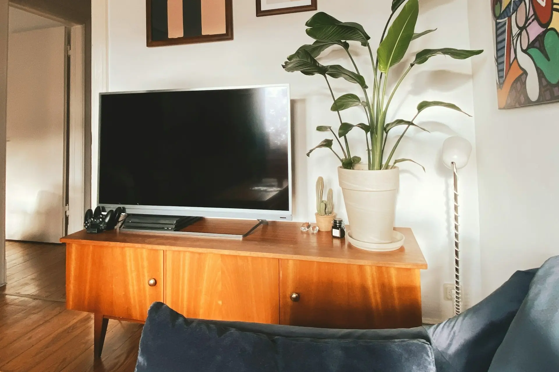 a flat screen tv sitting on top of a wooden dresser